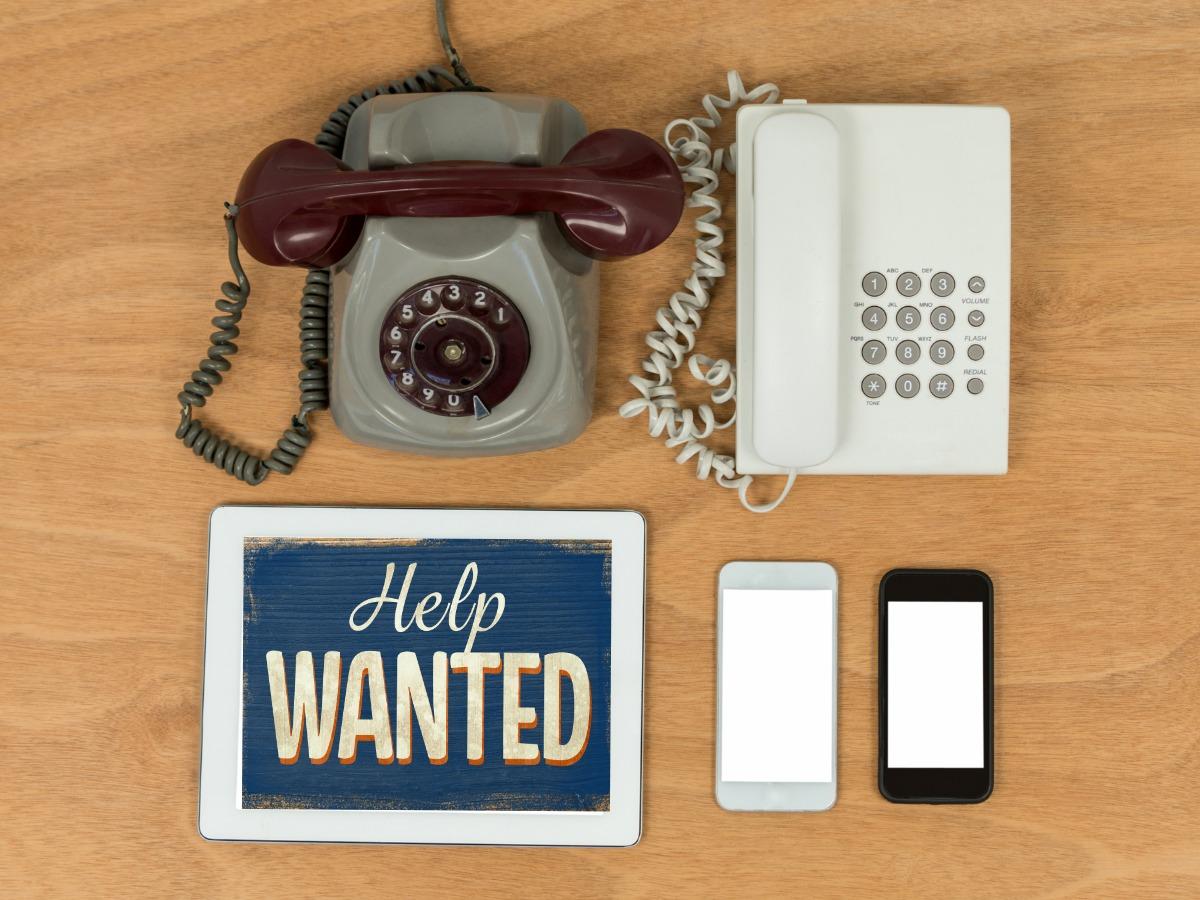 Vintage telephones on table next to modern smartphones - The biggest trends in graphic design - Image